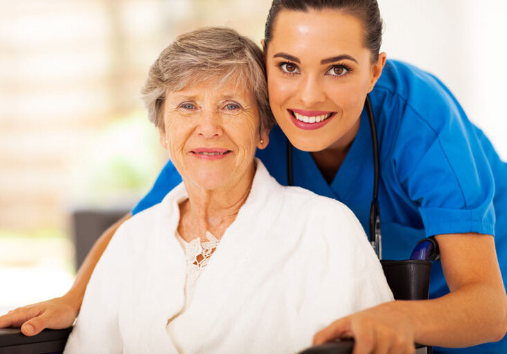 Nurse and an elderly female smiling